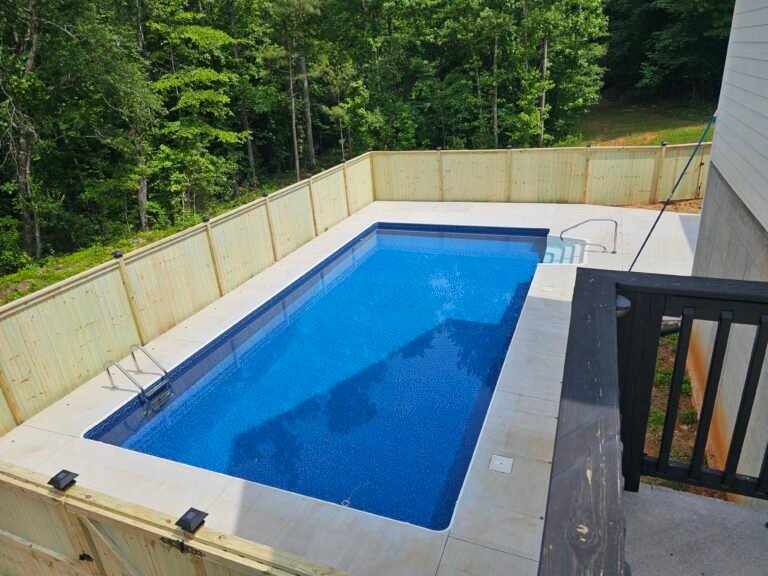 Capped wood privacy fence around a pool in Cartersville, Georgia
